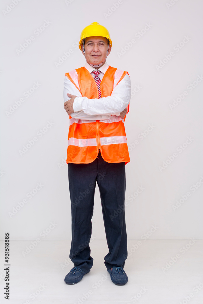 Full body front view of a middle aged asian construction project manager, site supervisor, engineer, or architect with arms crossed. Isolated on a white background. Full body front view of a middle aged asian construction project manager, site supervisor, engineer, or architect with arms crossed. Isolated on a white background.
