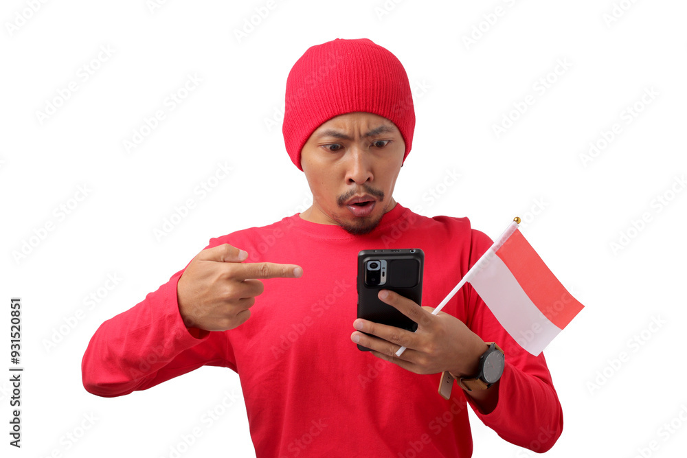Shocked Indonesian man receives an unexpected notification on his phone about special offers, discounts, and great deals during Indonesian Independence Day promo event, Isolated on a white background Shocked Indonesian man receives an unexpected notification on his phone about special offers, discounts, and great deals during Indonesian Independence Day promo event, Isolated on a white background