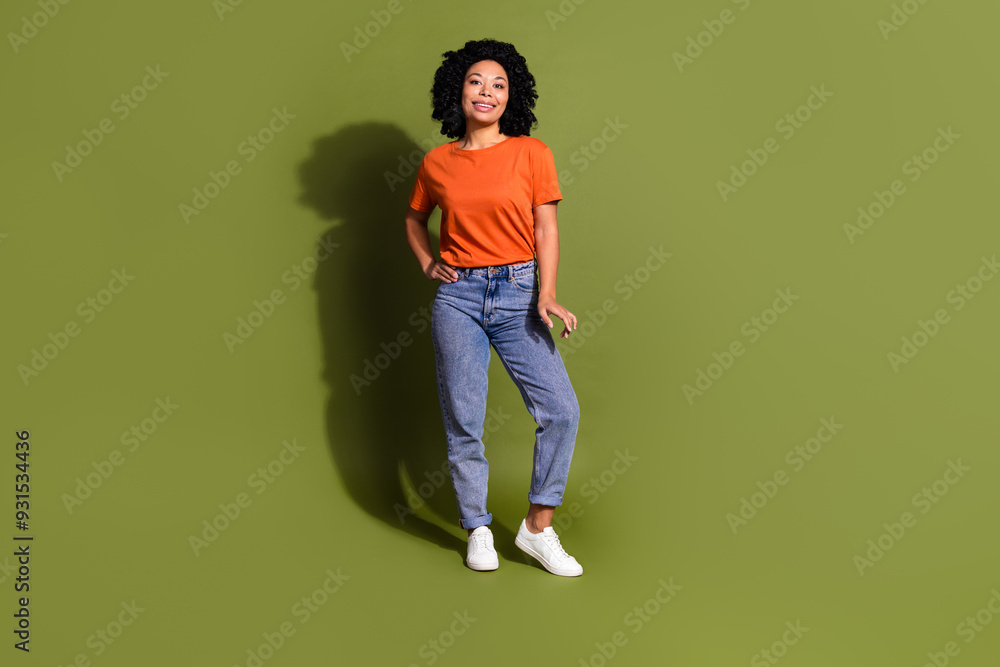 Full size photo of pretty young girl posing model wear trendy orange outfit isolated on khaki color background Full size photo of pretty young girl posing model wear trendy orange outfit isolated on khaki color background