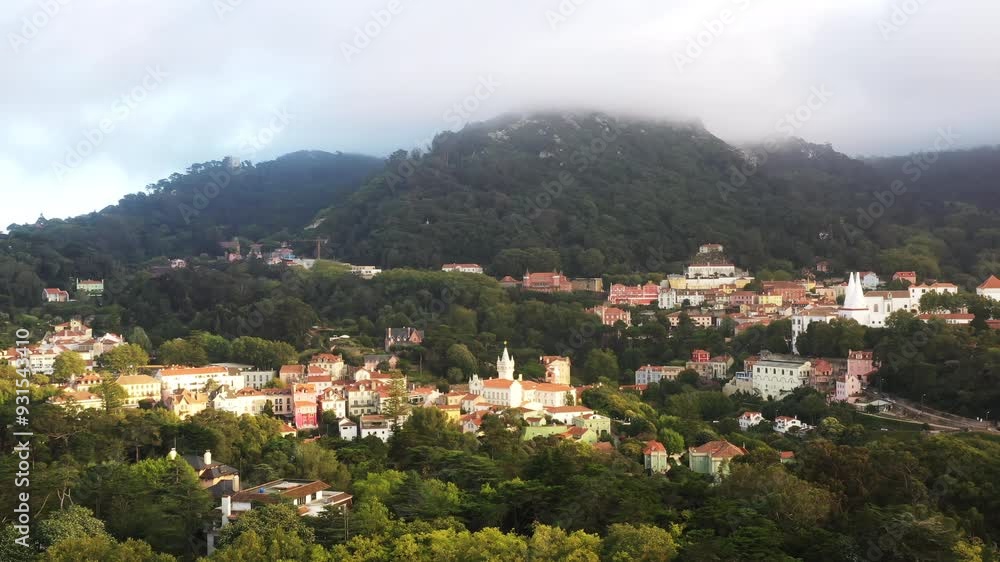 Aerial view of houses nestled in the lush green mountains surrounding Sintra Portugal showcasing the region's natural beauty and tranquil forested landscape Aerial view of houses nestled in the lush green mountains surrounding Sintra Portugal showcasing the region's natural beauty and tranquil forested landscape
