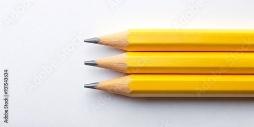 Three yellow pencils arranged parallel on background, perfect for back to school supplies concept, yellow