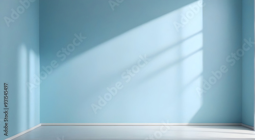 Sunlight casting shadows in empty room with blue walls