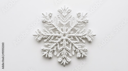 A delicate snowflake placed on a white background, its intricate details subtly visible.