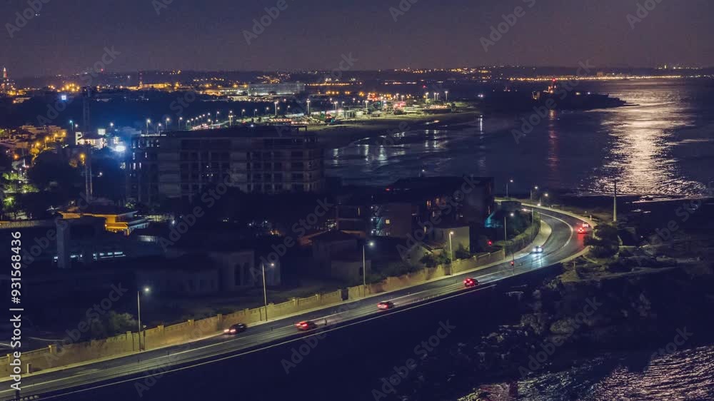 Bright moonlight casts shimmering reflections on the water, illuminating the coastline and city lights in the evening during a hyperlapse Bright moonlight casts shimmering reflections on the water, illuminating the coastline and city lights in the evening during a hyperlapse