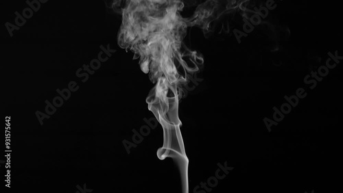 White natural steam or smoke rising from food or hot drink on black background.