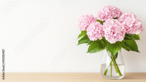 Wallpaper Mural Delicate white hydrangea blooms create a fresh, elegant display in a clear vase on a wooden table against a soft gray backdrop Torontodigital.ca