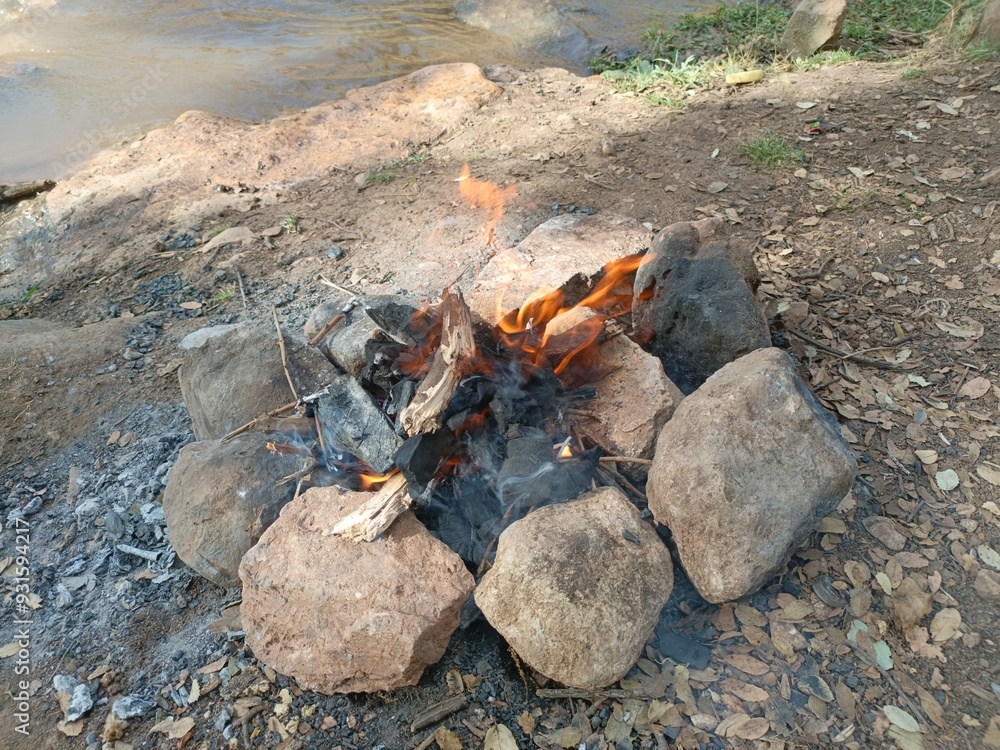 Ben Smim, Morocco - August 8, 2024: Lighting a barbecue fire in the middle of the Moroccan Middle Atlas Mountains, with the sound of running water creating an atmosphere of serenity and nature Ben Smim, Morocco - August 8, 2024: Lighting a barbecue fire in the middle of the Moroccan Middle Atlas Mountains, with the sound of running water creating an atmosphere of serenity and nature