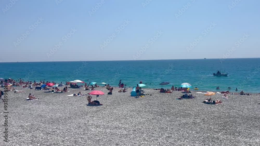 Beach in Nice, France. View of nice beach and promenade des Angles. Nice, Cote d'Azur. Promenade des anglais at sunset. French Riviera. European summer vacation, holidays concept. Mediterranean Sea Beach in Nice, France. View of nice beach and promenade des Angles. Nice, Cote d'Azur. Promenade des anglais at sunset. French Riviera. European summer vacation, holidays concept. Mediterranean Sea