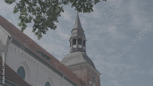 Valmiera, Larvia: ST. SIMONS CHURCH architecture close up shot slowmotion summer sunny day blue sky tree leaves FHD 10bit slog 3