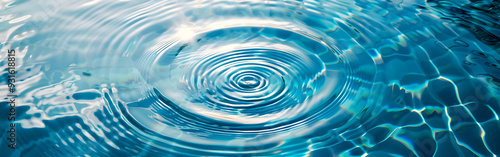 Captivating Close-Up of a Single Water Drop Creating an Intricate Ripple Effect with Sunlight Dancing Across the Blue-Tinted Surface