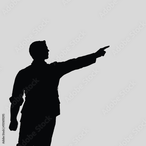 Silhouette of a man pointing forward against a plain gray background.