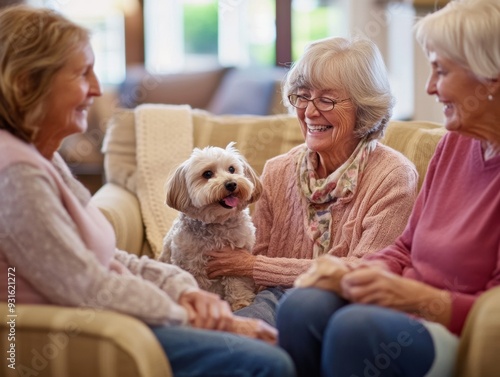 Three elderly women are sitting on a couch with a dog at the nursing home