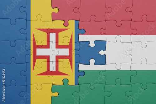 puzzle with the colourful national flag of hungary and flag of madeira. photo