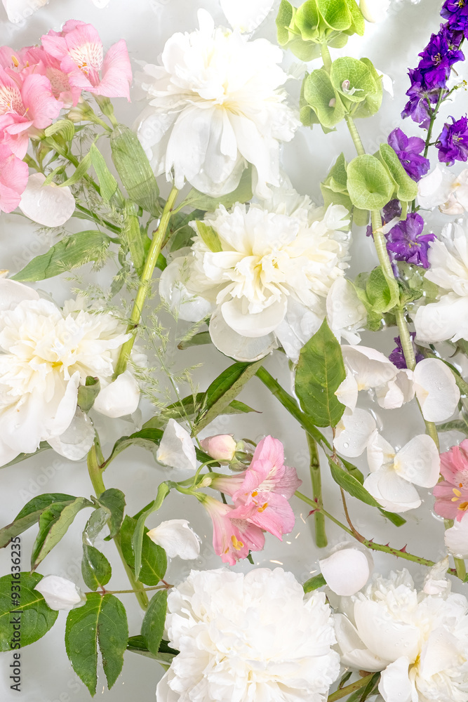 Elegant Floral Arrangement of Various Blossoms float in the water. Top view. Elegant Floral Arrangement of Various Blossoms float in the water. Top view.