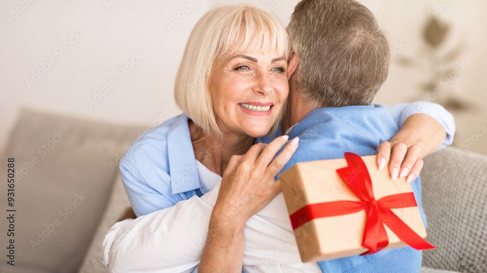 Happy wife hugging husband for the present, being grateful for birthday gift Happy wife hugging husband for the present, being grateful for birthday gift