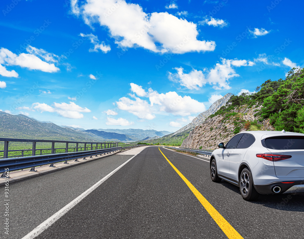The car is driving along the highway surrounded by picturesque nature. The car is driving along the highway surrounded by picturesque nature.