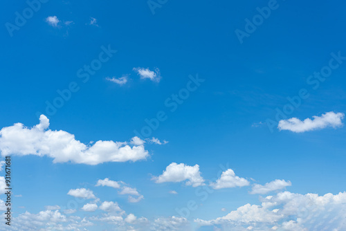 Bright blue sky with fluffy white clouds on a sunny day