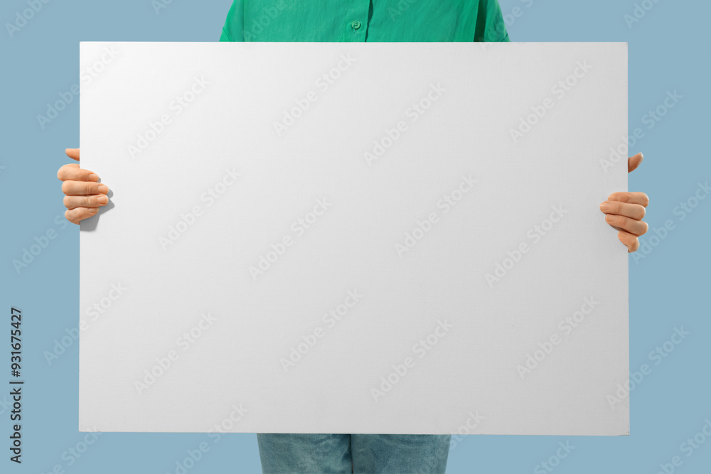 Unrecognizable person holding white canvas with empty place for text in hands Unrecognizable person holding white canvas with empty place for text in hands