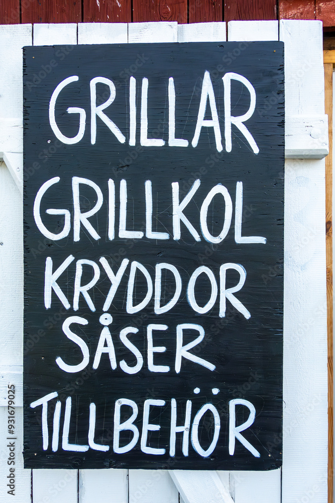 Oregrund, Sweden A sign in Swedish on the side of a red barn advertises Grills, coal, spices, sauces and extras. Oregrund, Sweden A sign in Swedish on the side of a red barn advertises Grills, coal, spices, sauces and extras.