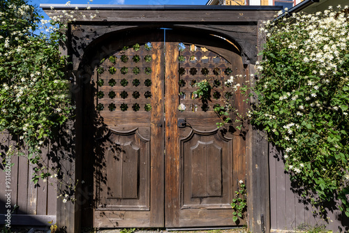 Oregrund, Sweden AUg 19, 2024 An old and weatehred wooden door to a garden. photo