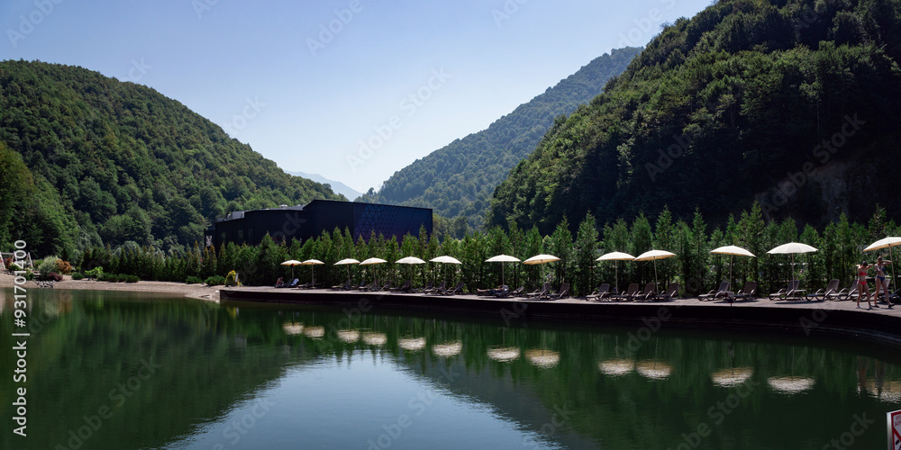 Fototapeta premium sun loungers at the pool with umbrellas