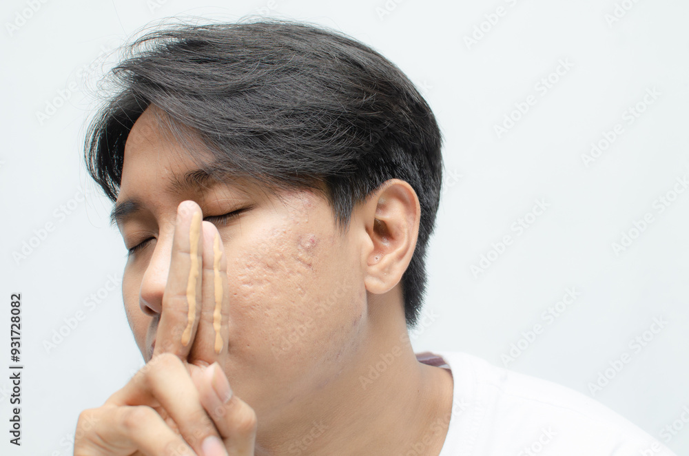 Close-up of a young asian man shirtless applying skincare cream to his face. skincare concept of asian man bare face. Close-up of a young asian man shirtless applying skincare cream to his face. skincare concept of asian man bare face.