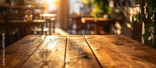 Chosen focus on an empty brown wooden table with a blurred background of a coffee shop featuring a bokeh effect intended for product display montage. with copy space image