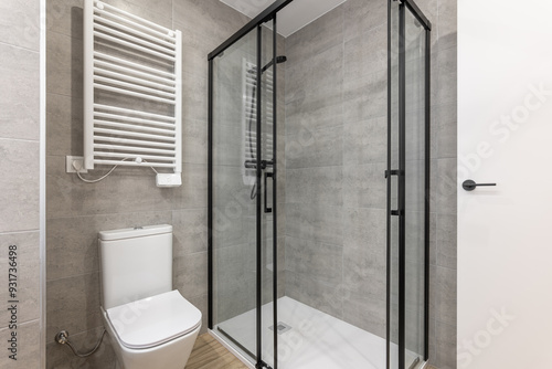 Modern bathroom with glass shower and slim toilet complements the stylish design of the apartment
