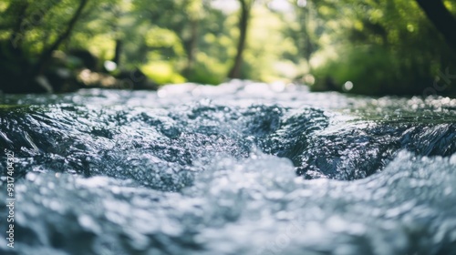 A focused image of a running river, the camera lens capturing the movement of water in sharp detail.