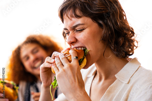 Fotografie Multiethnic group of friends having meal at 80s vintage diner restaurant, woman