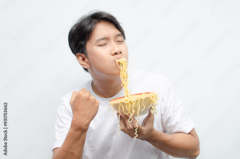 asian man smelling, enjoying, and licking with pleasure delicious noodles. a man gives delicious expressions while eating noodles. asian man smelling, enjoying, and licking with pleasure delicious noodles. a man gives delicious expressions while eating noodles.