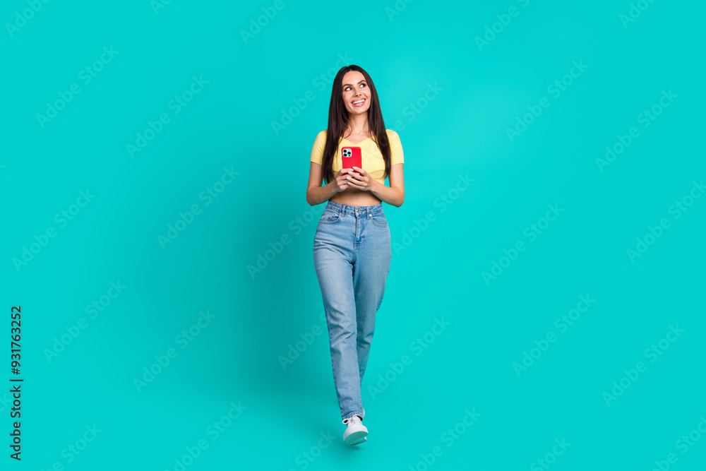 Full body portrait of pretty young woman walk look empty space wear top isolated on turquoise color background Full body portrait of pretty young woman walk look empty space wear top isolated on turquoise color background