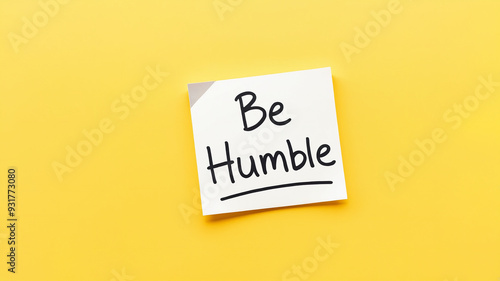 Be humble reminder handwritten note on yellow background