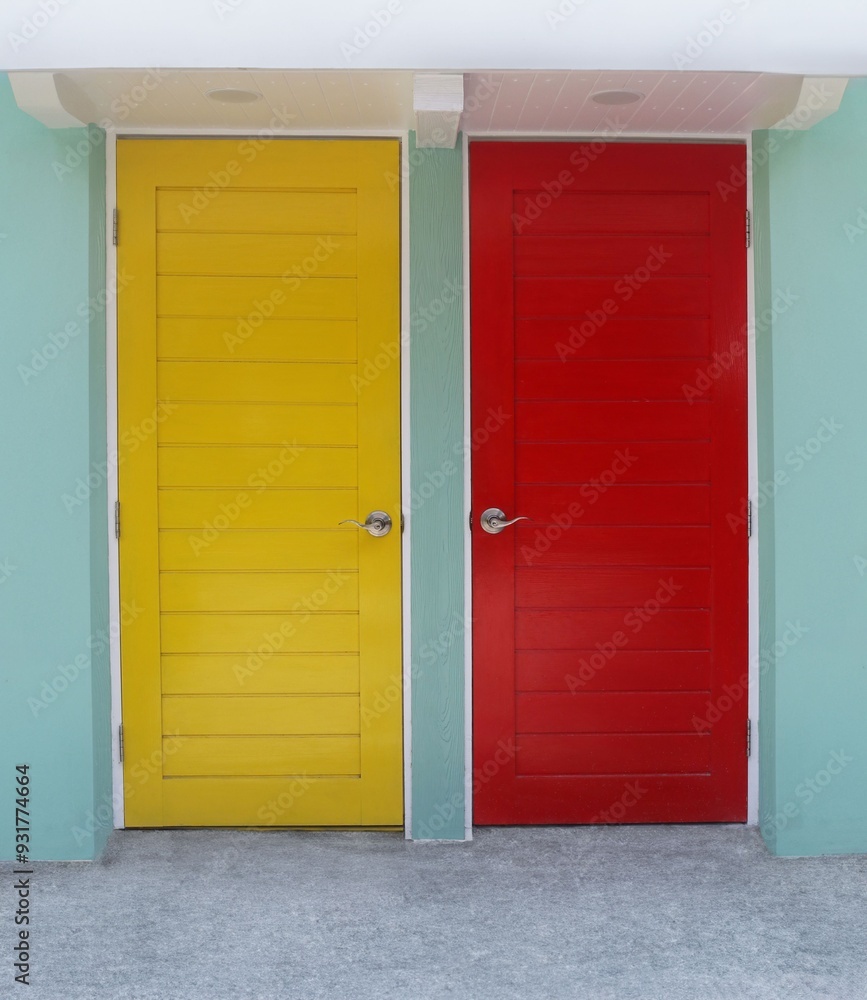Yellow and red room door mounted on green wall. Yellow and red room door mounted on green wall.