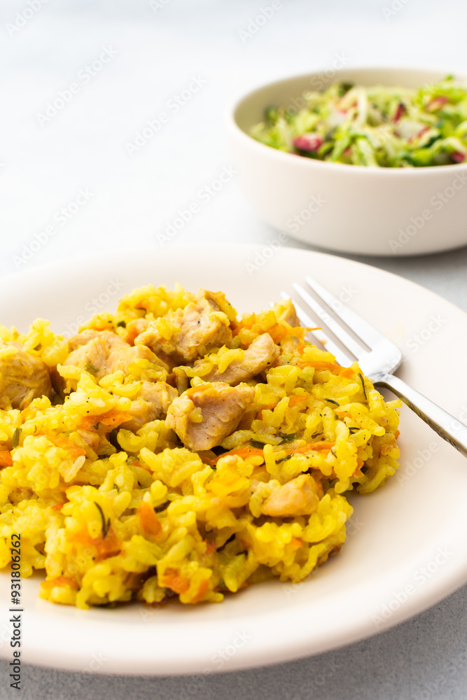 Stewed rice with chicken breast and mixed salad with radishes and various seeds, a delicious hearty lunch or dinner Stewed rice with chicken breast and mixed salad with radishes and various seeds, a delicious hearty lunch or dinner