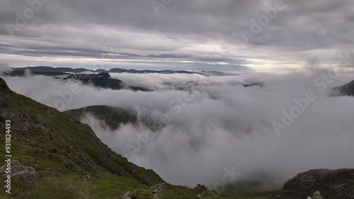 Timelapse of cloud inversion moving in valley over mountains