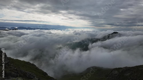 Timelapse of cloud inversion moving in valley over mountains