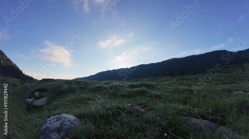 Sunrise timelapse in a grassy mountain valley 