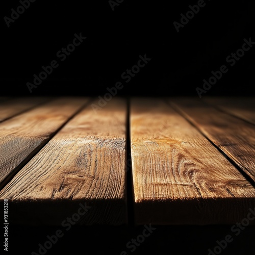 Elegant wooden surface illuminated softly against a black background, creating a warm and inviting atmosphere.