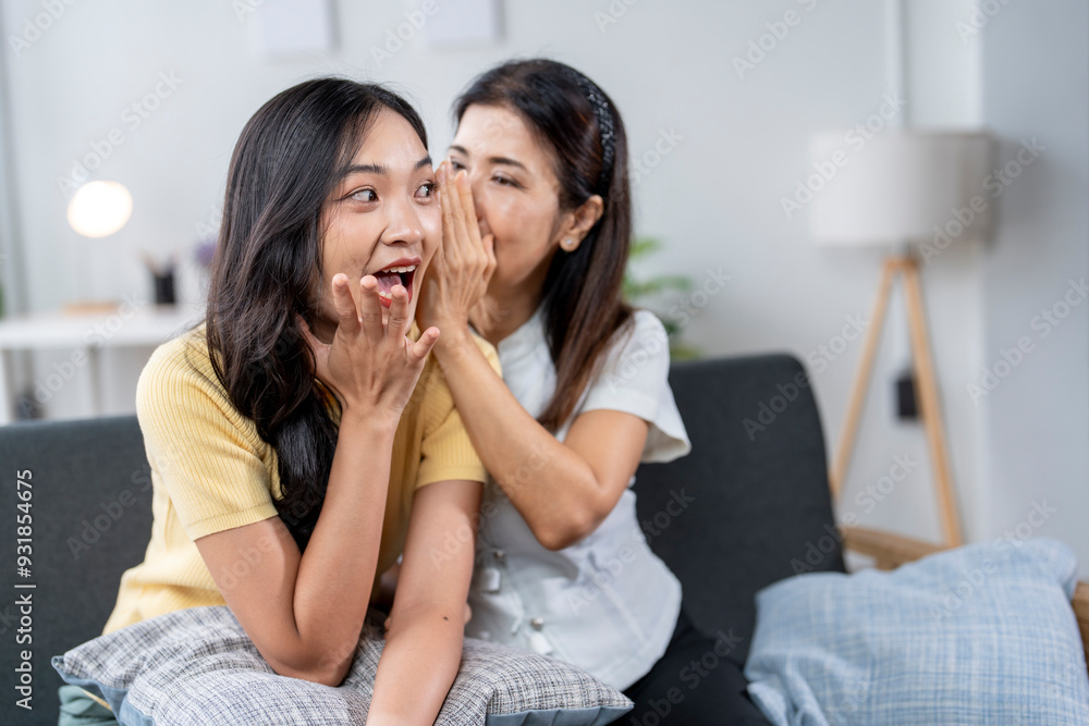 Two women are sitting on a couch, one of them is making a loud noise Two women are sitting on a couch, one of them is making a loud noise