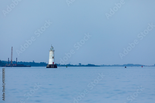 The Great Beds Lighthouse is seen across the Raritan Bay from South Amboy on a beautiful summer evening during golden hour