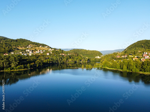 A lake located between mountains, aerial drone view. A natural lake between the hills. Plivsko lake, Jajce, Bosnia and Herzegovina. 