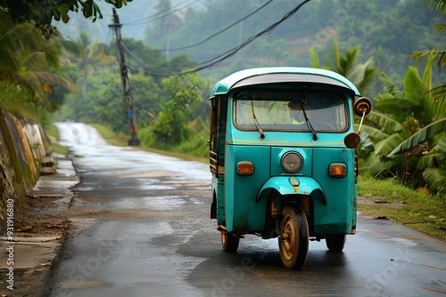 Charming Vintage Tuk-Tuk on a Rainy Road Surrounded by Lush Greenery photo