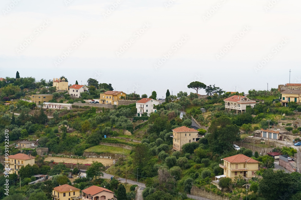 A Verdant Hillside Village Nestled Among Lush Greenery Under a Misty Morning Sky A Verdant Hillside Village Nestled Among Lush Greenery Under a Misty Morning Sky