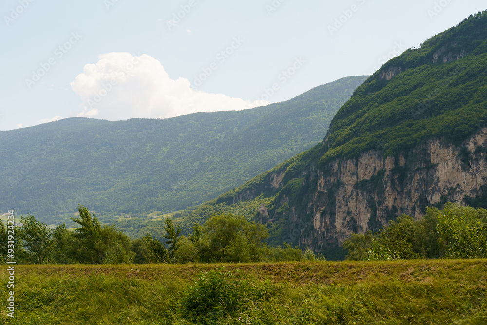 A Majestic Mountain Range Basking Under a Fluffy Cumulus Cloud in a Sunny Summer Sky A Majestic Mountain Range Basking Under a Fluffy Cumulus Cloud in a Sunny Summer Sky