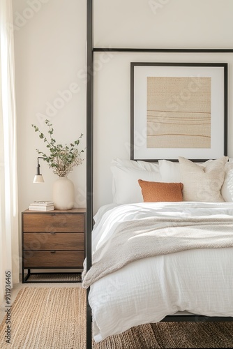 Wallpaper Mural A stylish bedroom featuring a canopy bed with white linens, a minimalist nightstand, and a large framed artwork on the wall, illuminated by warm ambient light. Torontodigital.ca