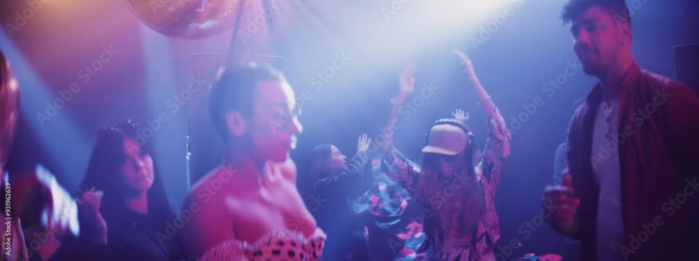 Group of people or audience dancing on the dance floor for cheers or energy in dark night club Group of people or audience dancing on the dance floor for cheers or energy in dark night club