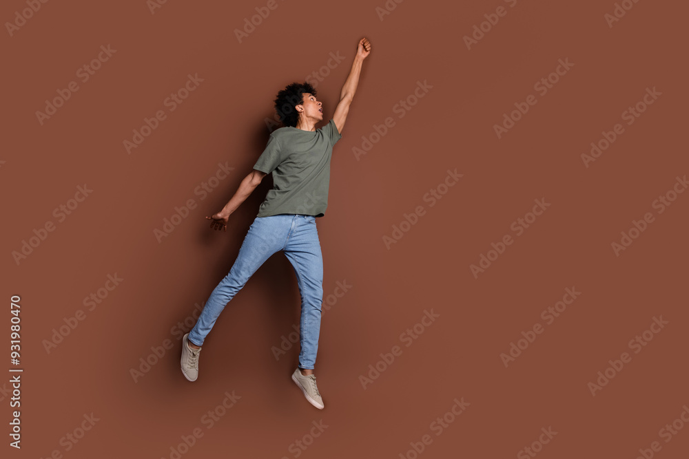 Full size photo of nice young guy hanging empty space wear trendy khaki outfit isolated on brown color background Full size photo of nice young guy hanging empty space wear trendy khaki outfit isolated on brown color background