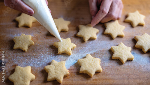 Six-Point Star Cookies on a Wooden Surface Being Decorated with Frosting photo