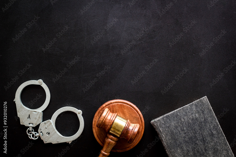 Police metal handcuffs with criminal code book and judges gavel. Law and justice concept Police metal handcuffs with criminal code book and judges gavel. Law and justice concept